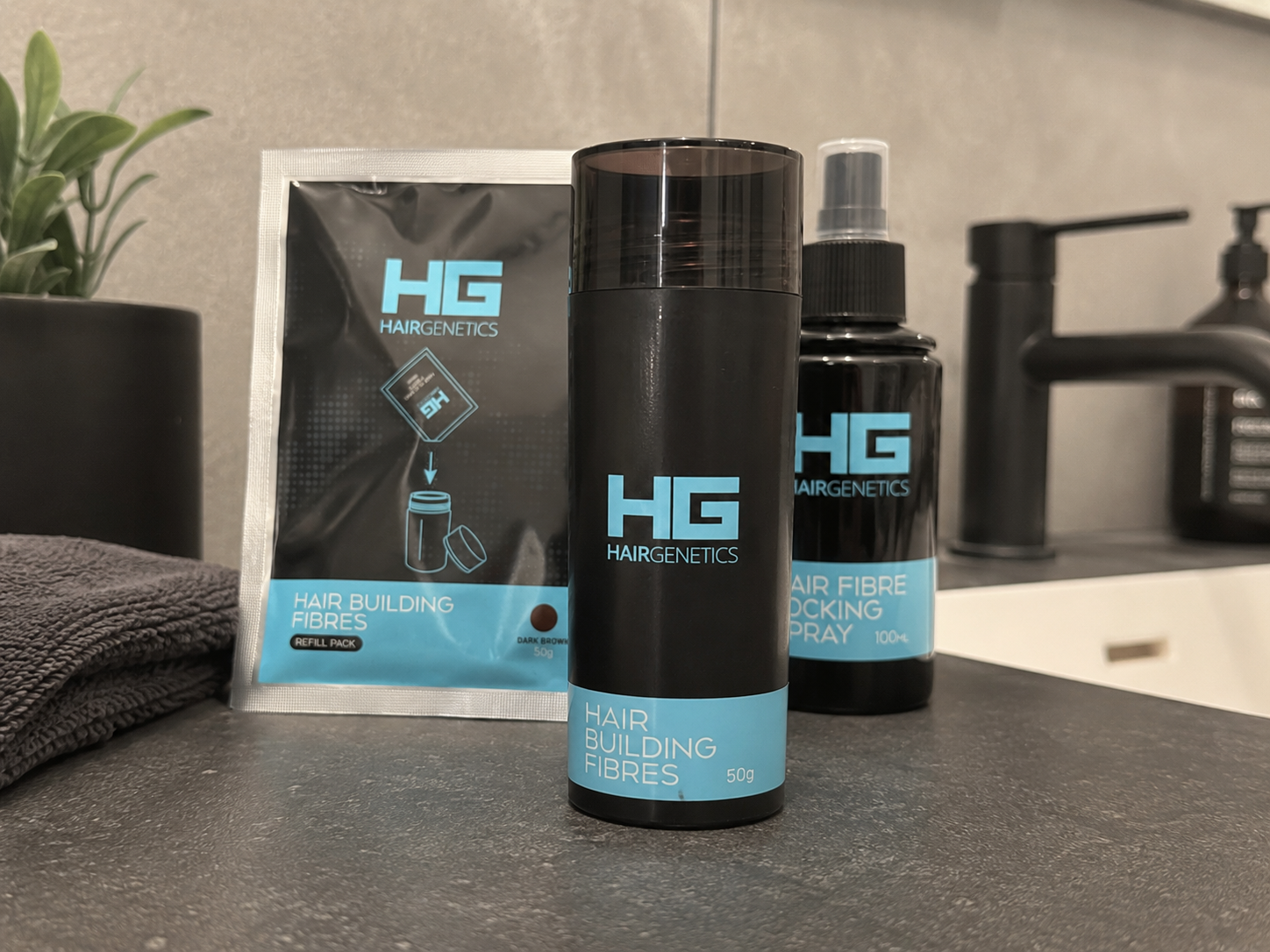 Hair Genetics bottle, refill pack and locking spray on a bathroom counter